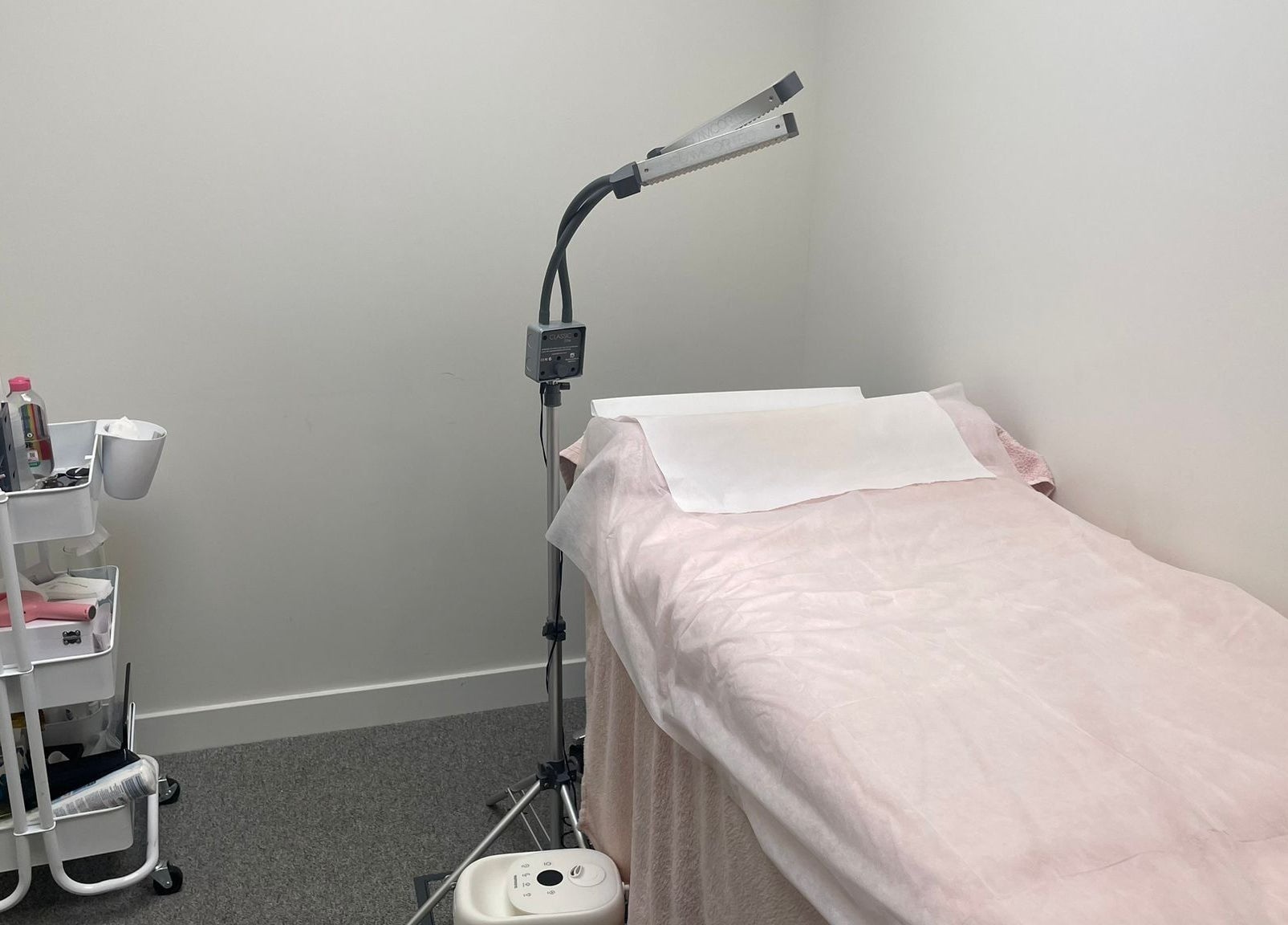 Private treatment room at (Closed) Battersea - Wish Beaute, London, England, GB, with a bed and equipment.