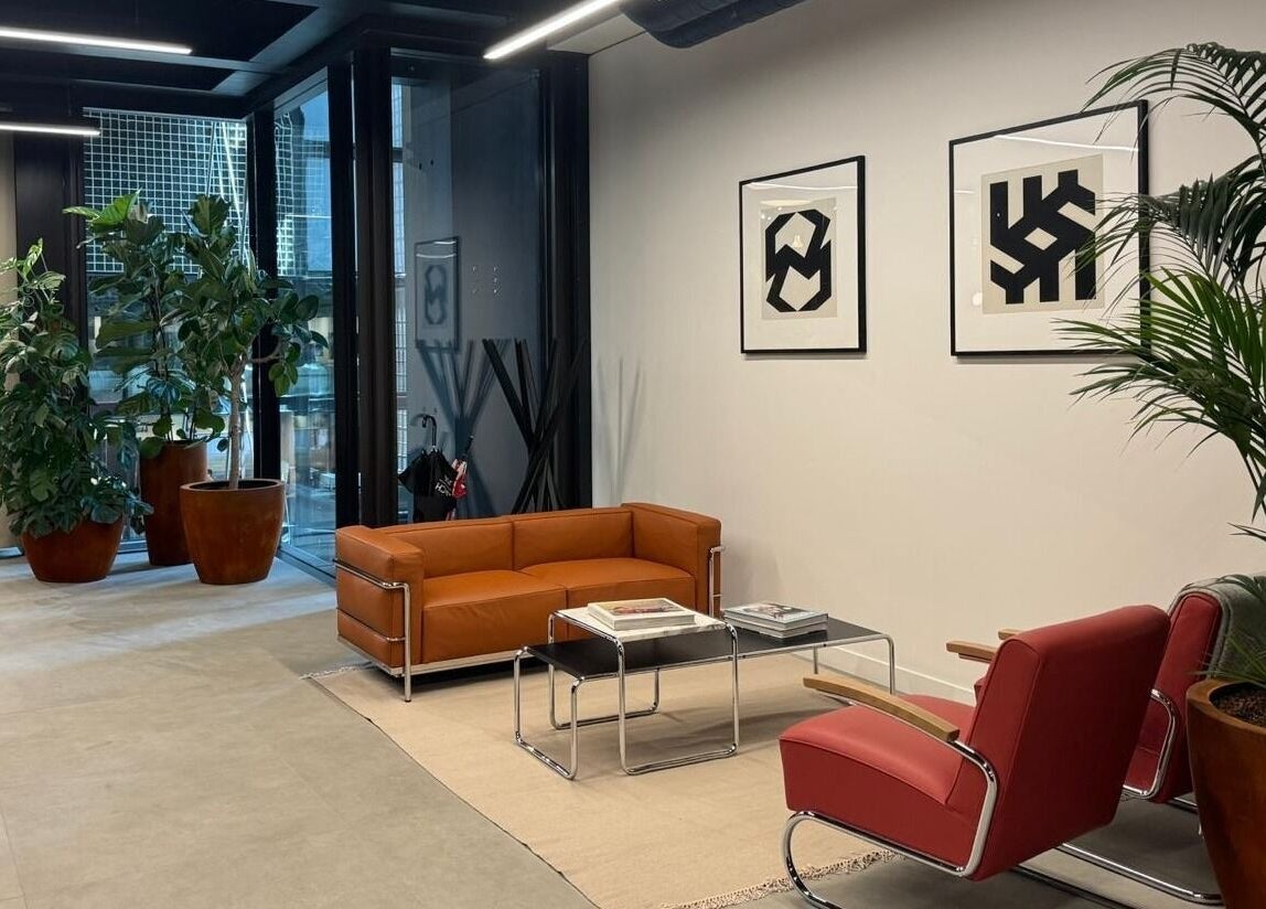 Stylish lounge area at (Closed) Battersea - Wish Beaute, London, England, GB with modern furniture and plants.