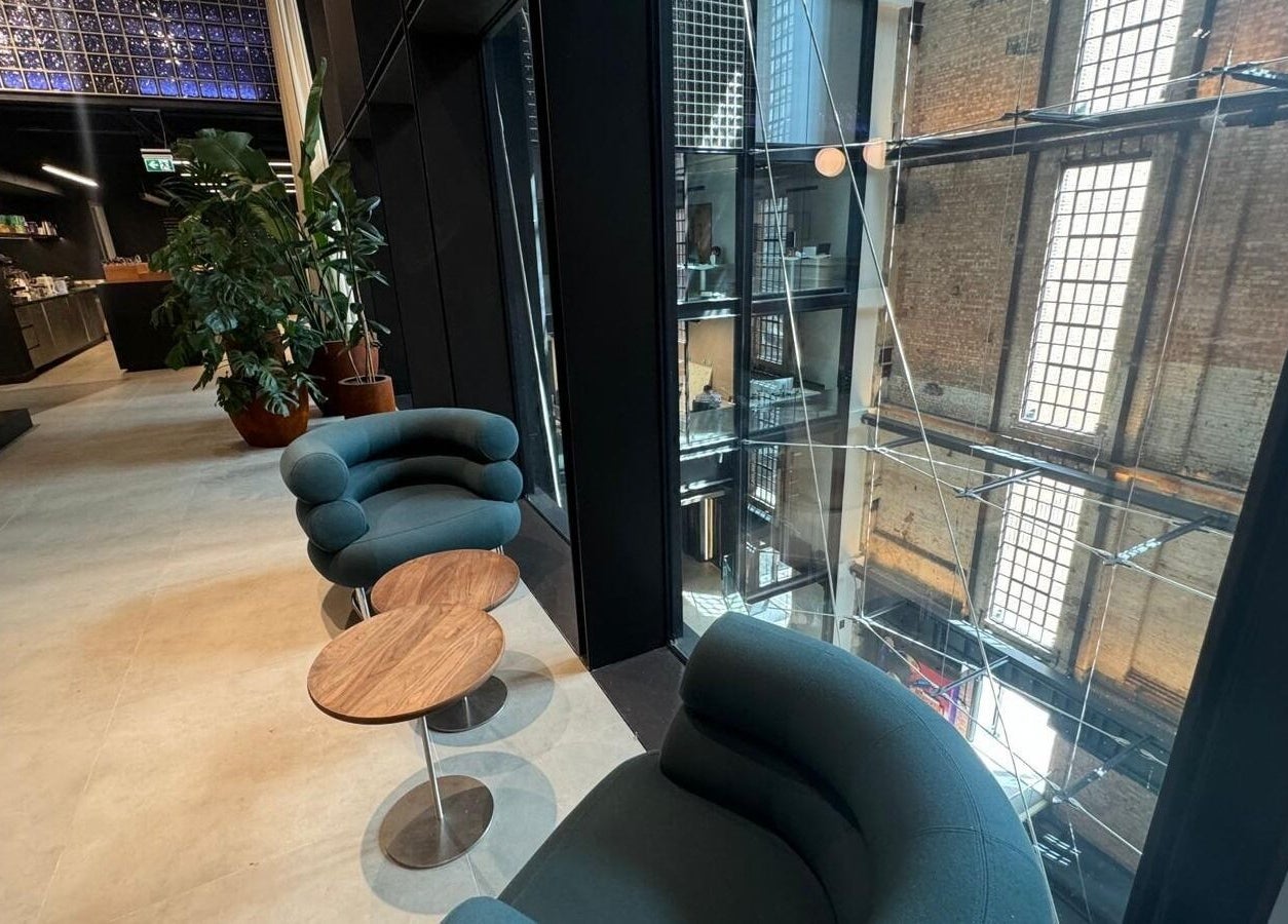 Modern seating area at (Closed) Battersea - Wish Beaute, London, England, GB, with stylish chairs and tall windows.