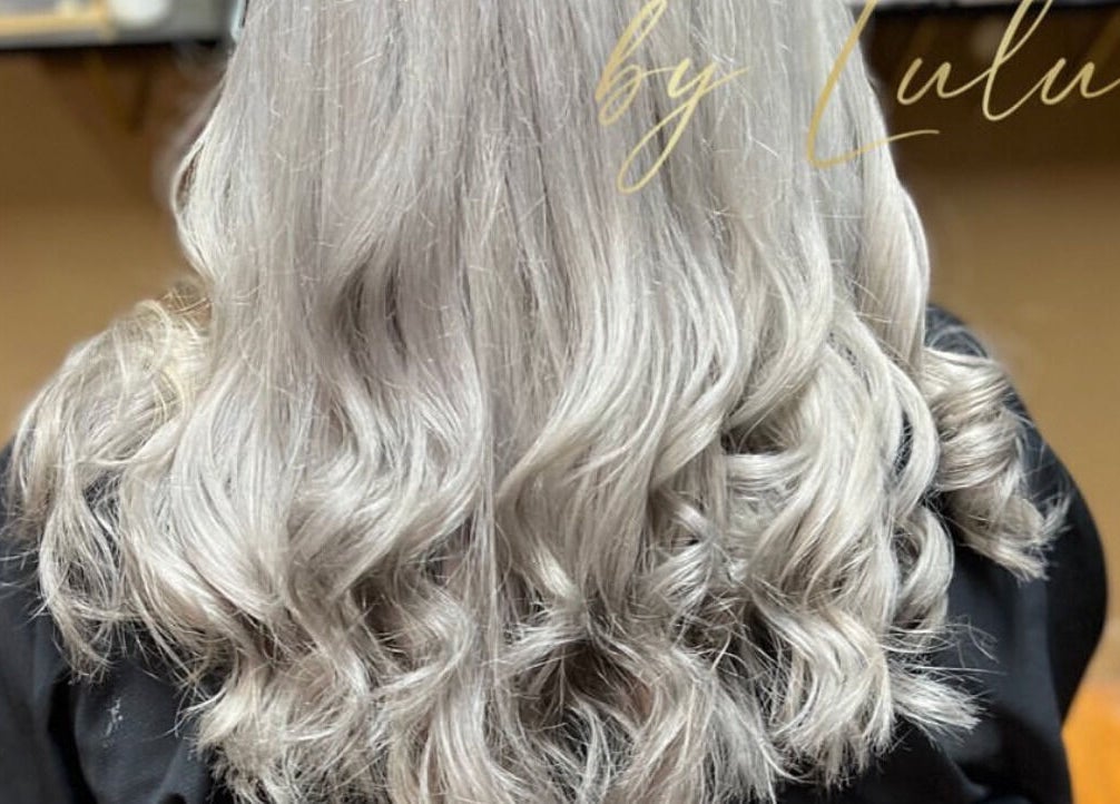 Elegant, wavy silver hair styling at Kosmetikos in Sherman, Texas, US.