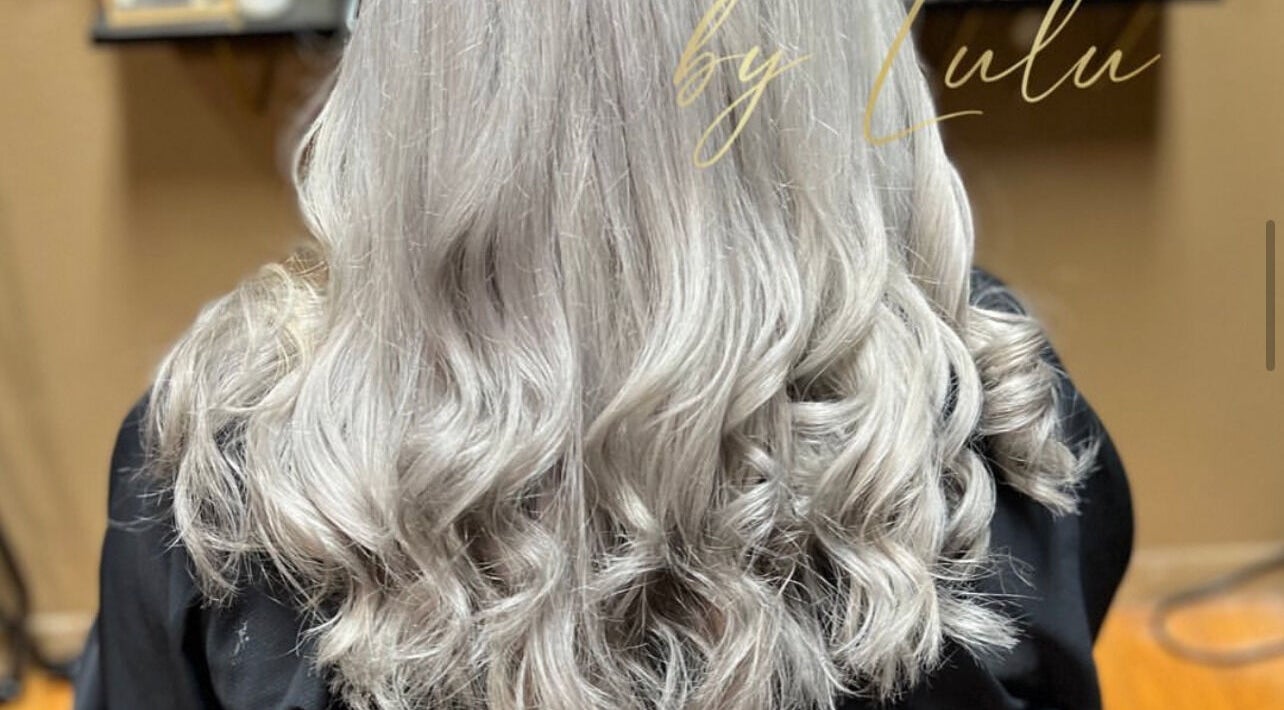 Elegant, wavy silver hair styling at Kosmetikos in Sherman, Texas, US.