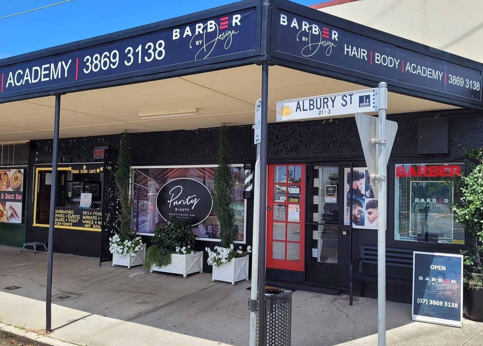 Street view of Barber by Design, Deagon, Queensland, AU showcasing inviting entrance and signage.