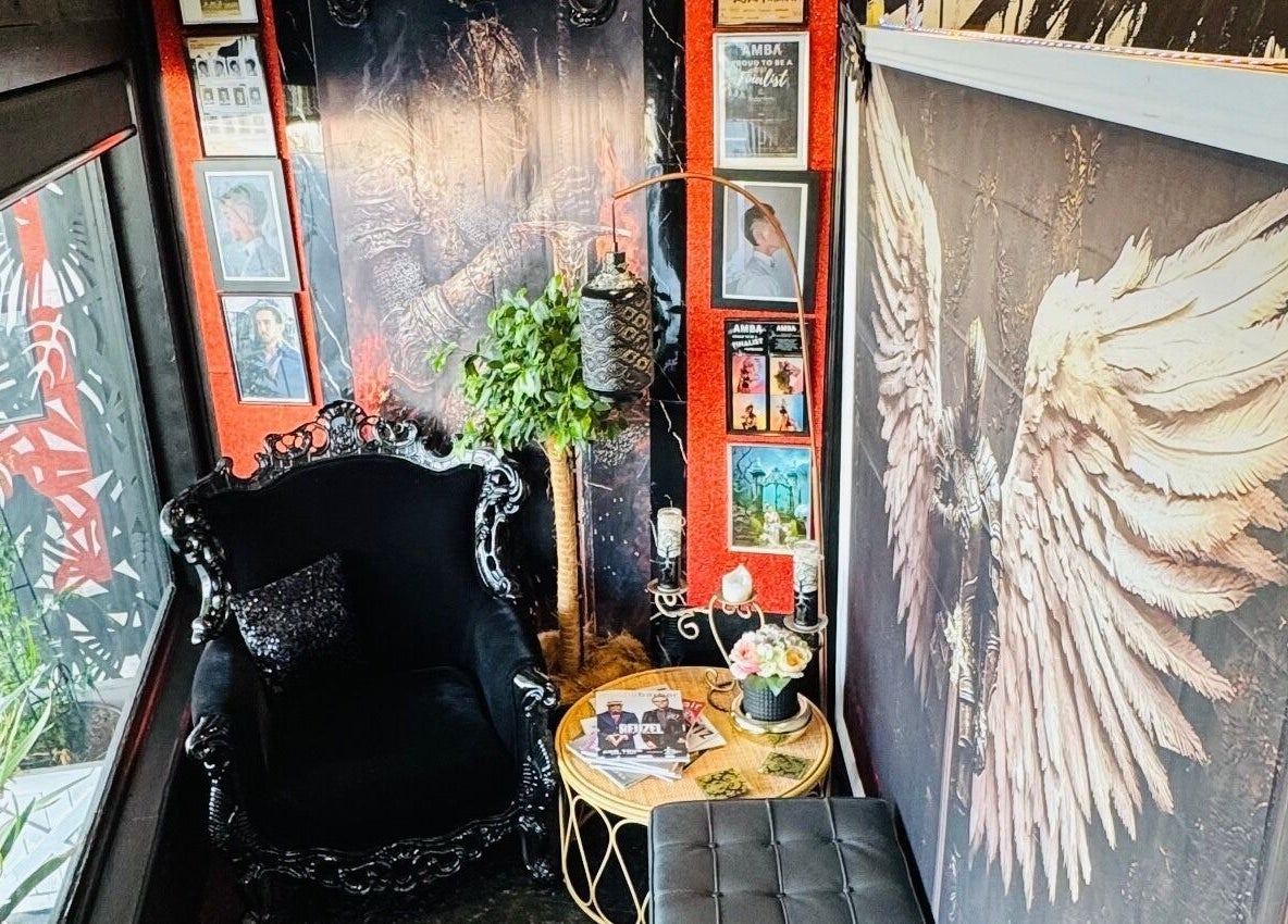 Cozy lounge chair with artistic wall decor at Barber by Design, Deagon, Queensland, AU.