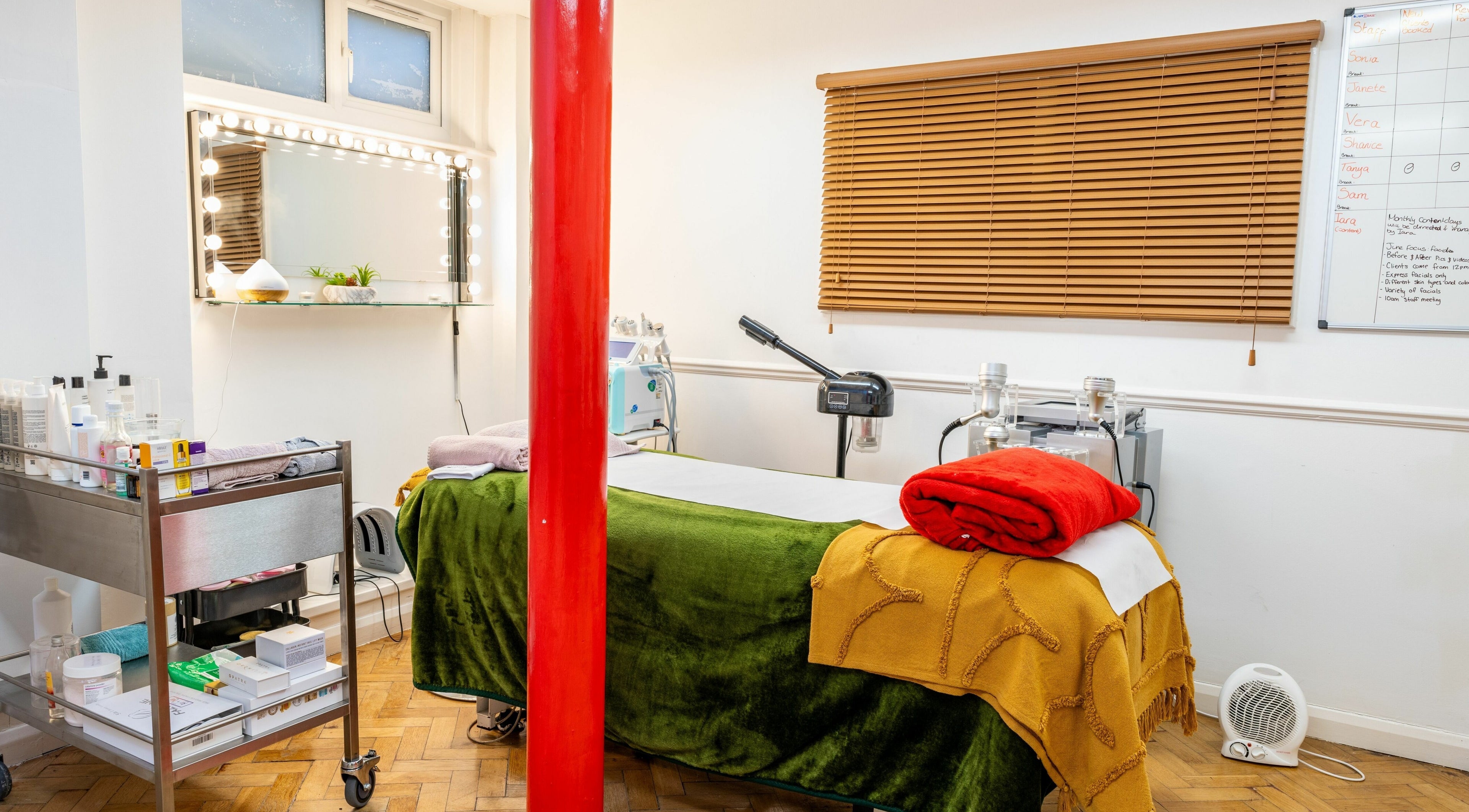 Tranquil treatment room at Flawless Aesthetics by SB Ltd in Woodford Green, England, with cozy decor.