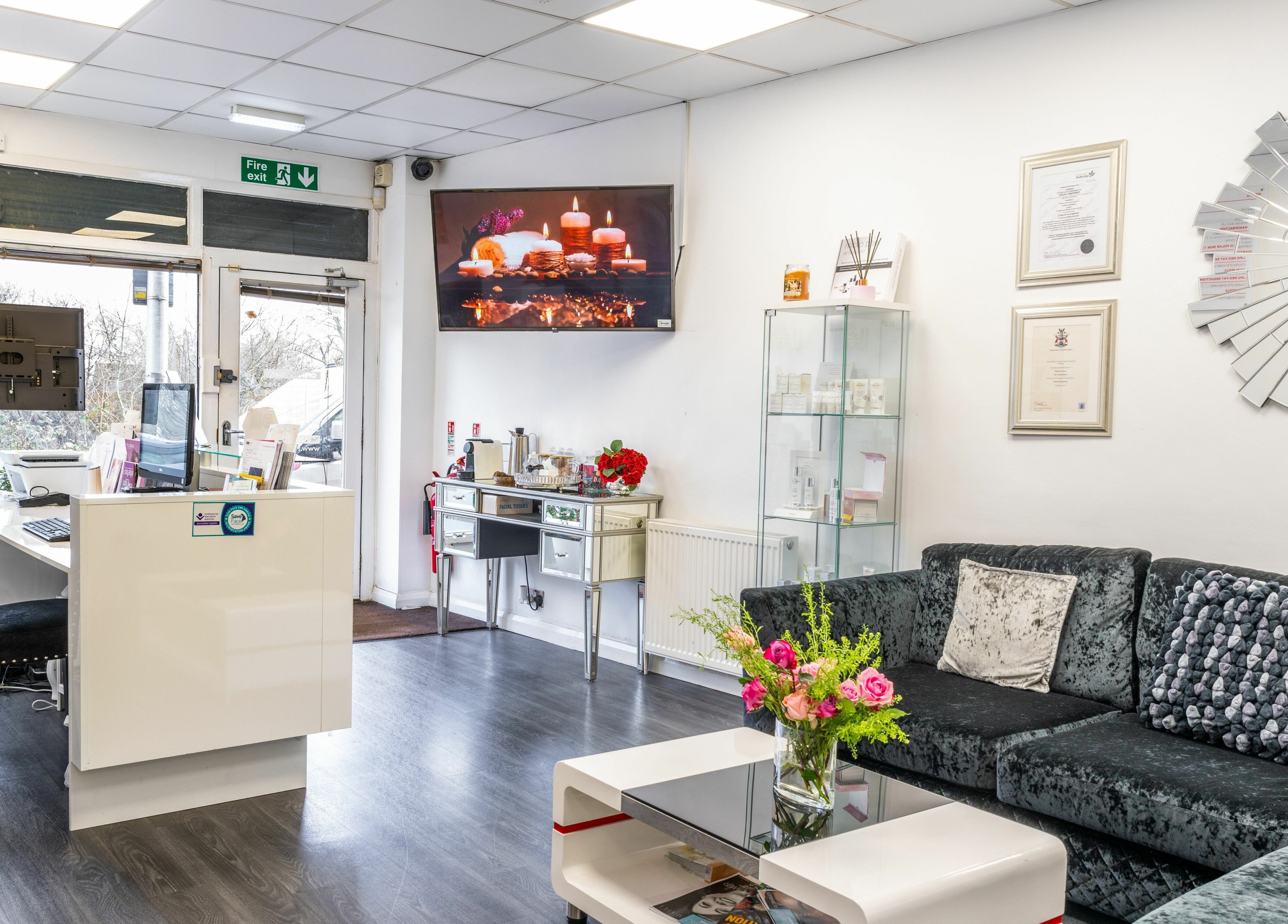 Reception area of Flawless Aesthetics by SB Ltd, Woodford Green, England, inviting atmosphere with flowers.