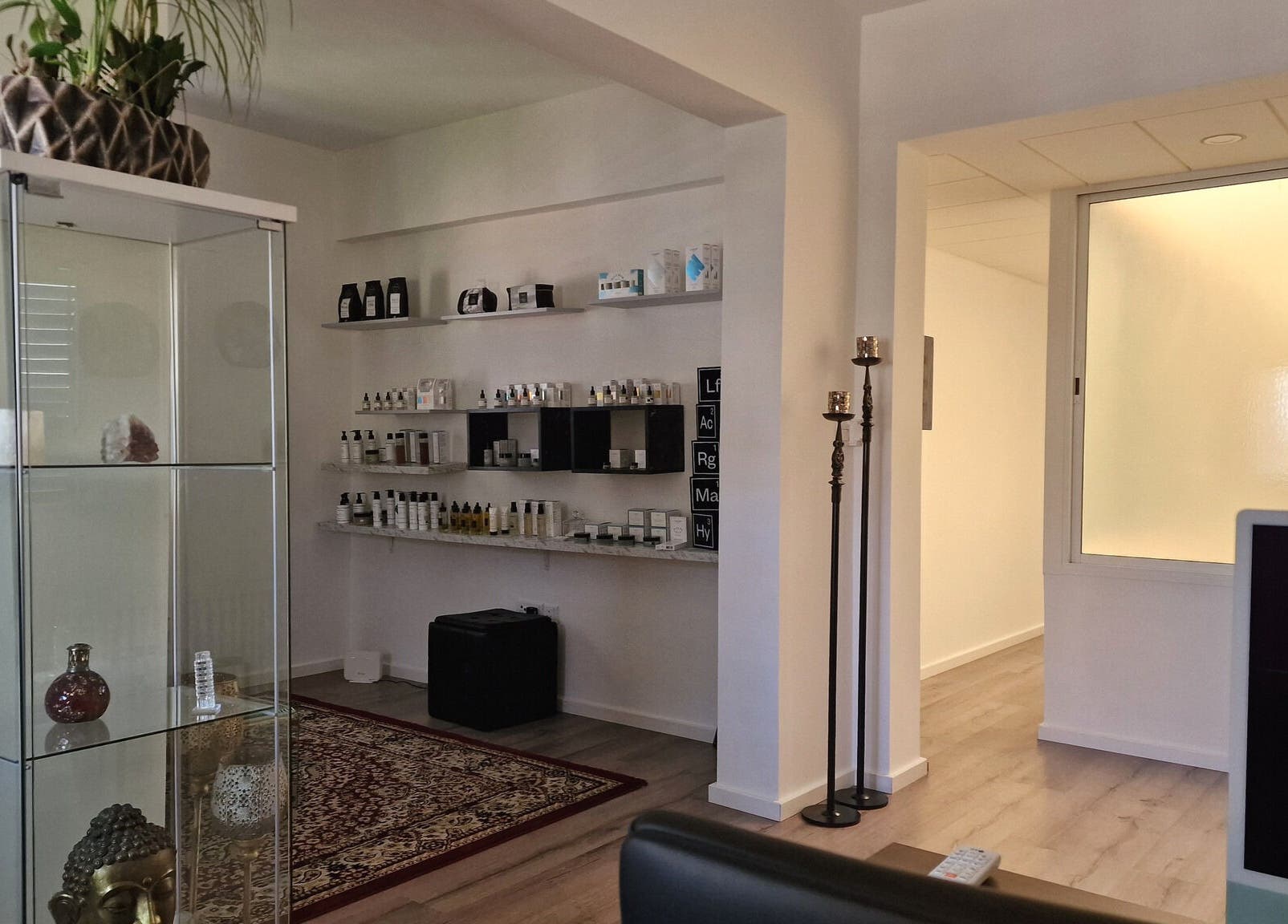 Calm wellness space at Salvatore, Germasogeia, Limassol, CY with beauty products on elegant shelves.