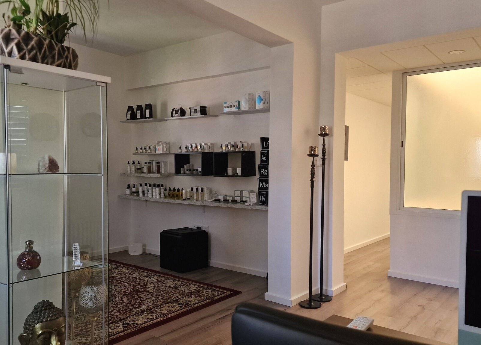 Calm wellness space at Salvatore, Germasogeia, Limassol, CY with beauty products on elegant shelves.