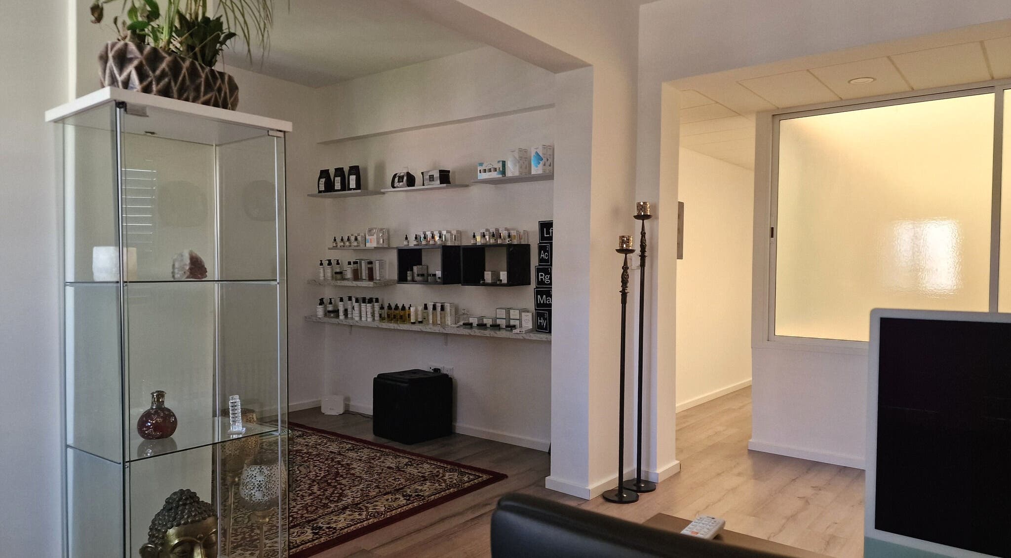 Calm wellness space at Salvatore, Germasogeia, Limassol, CY with beauty products on elegant shelves.