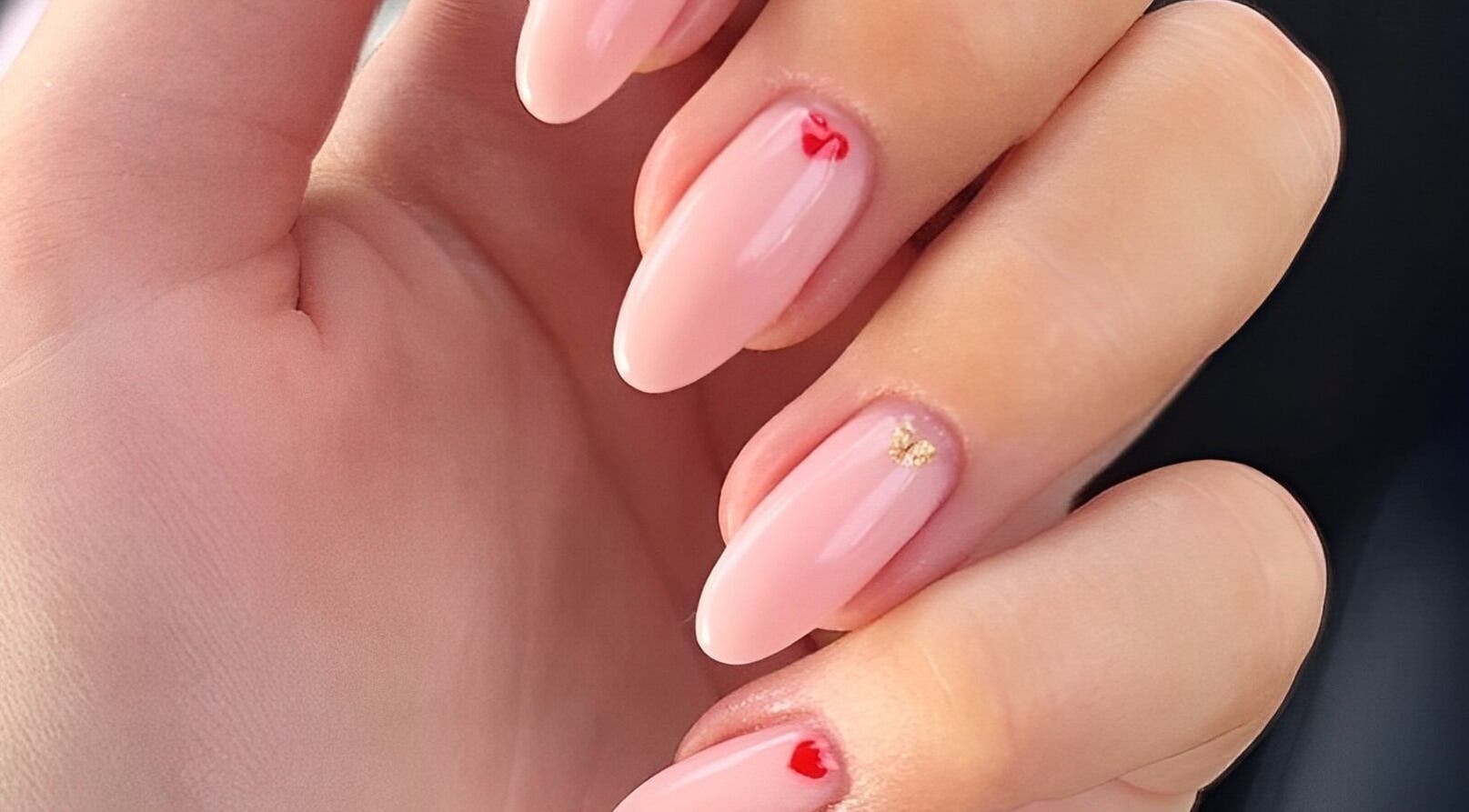 Elegant nail art at Wondernails by Jojo, Glasgow, Scotland, GB. Pink nails with small red and gold details.