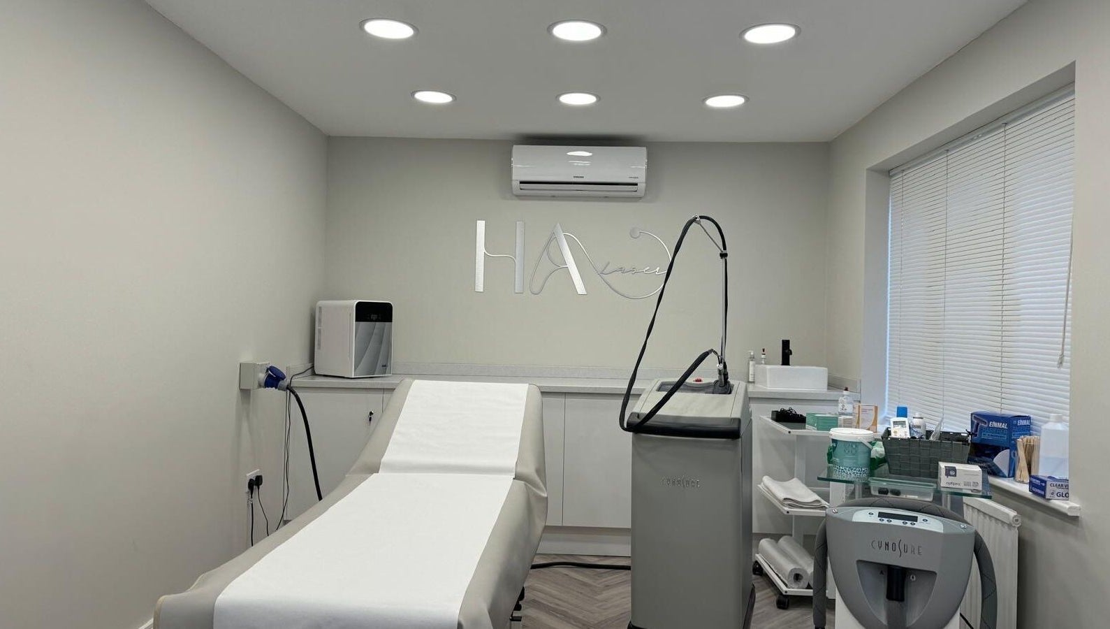 Sleek laser treatment room at HA Laser Studio in Basingstoke, England, GB, equipped with advanced technology.