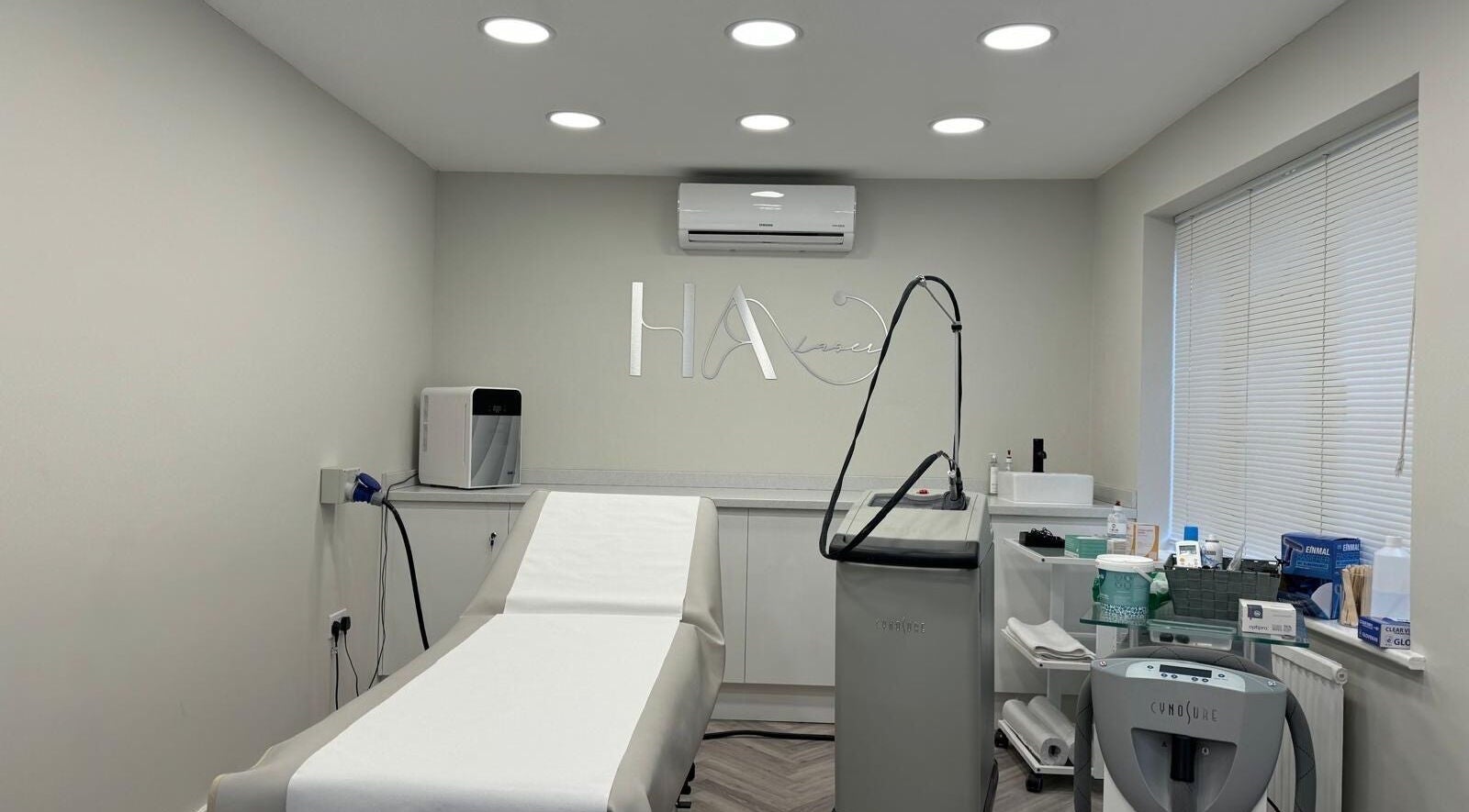 Sleek laser treatment room at HA Laser Studio in Basingstoke, England, GB, equipped with advanced technology.