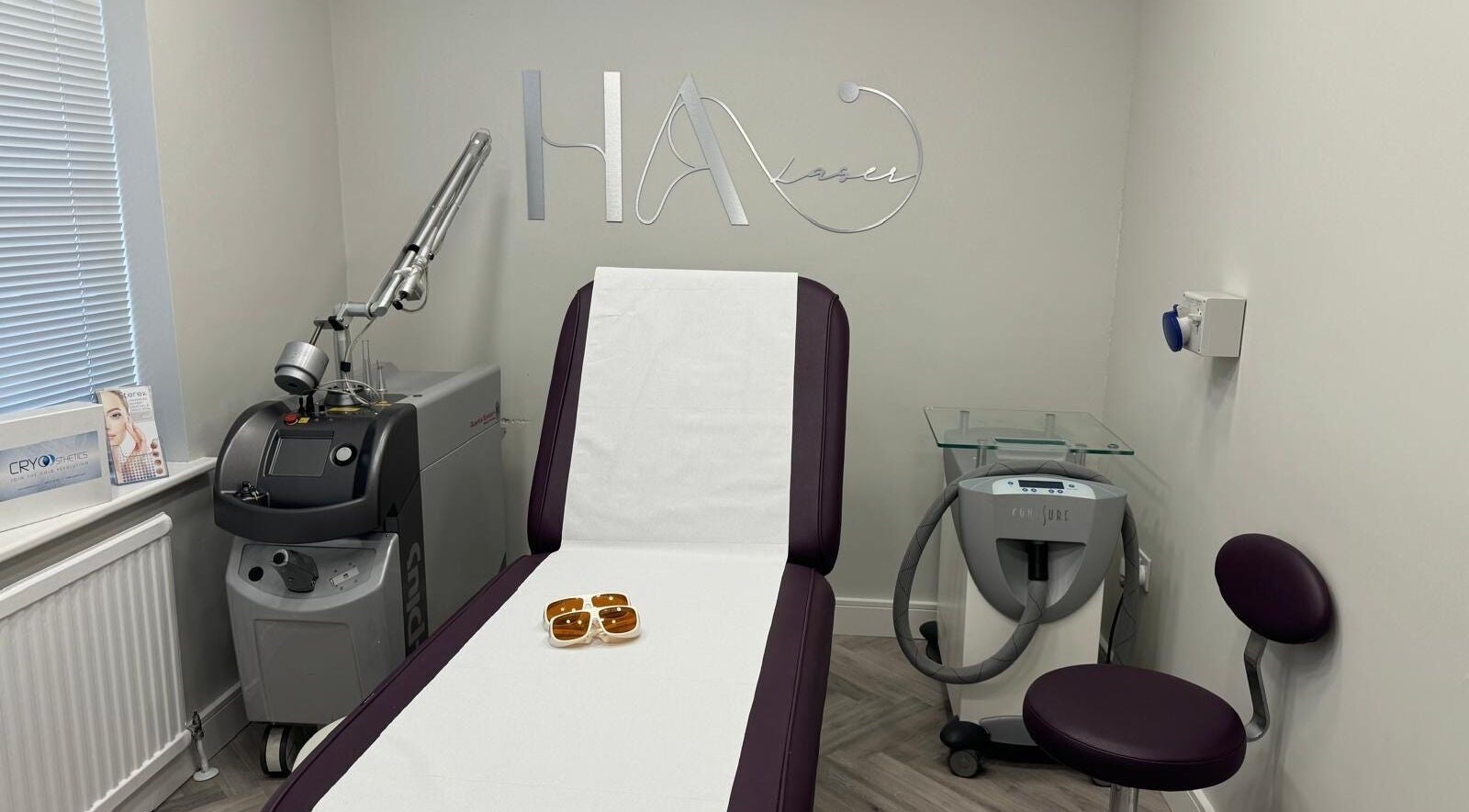HA Laser Studio treatment room in Basingstoke, England, GB, featuring a modern laser machine and treatment chair.