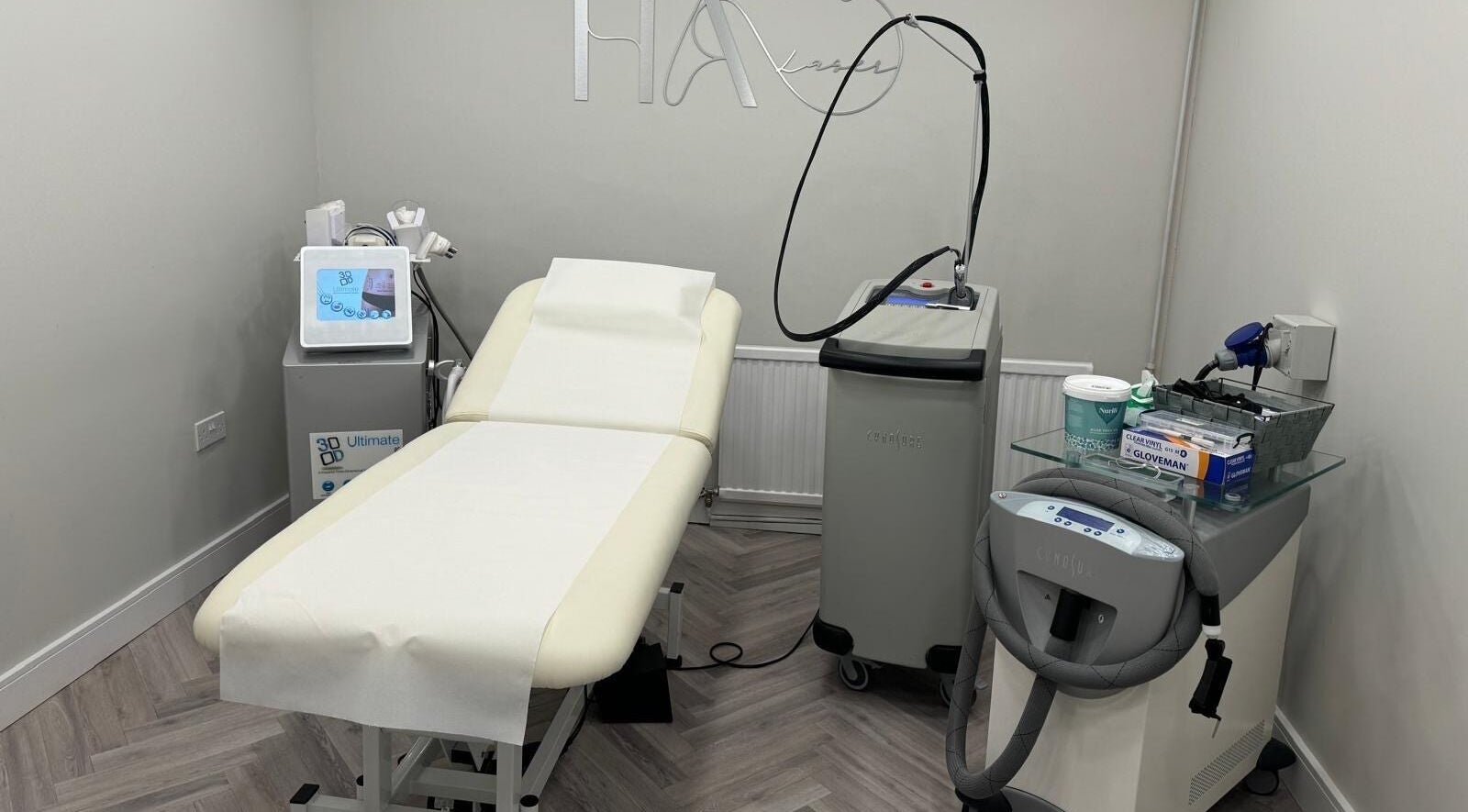 Modern treatment room at HA Laser Studio, Basingstoke, England, GB, showcasing advanced beauty equipment.