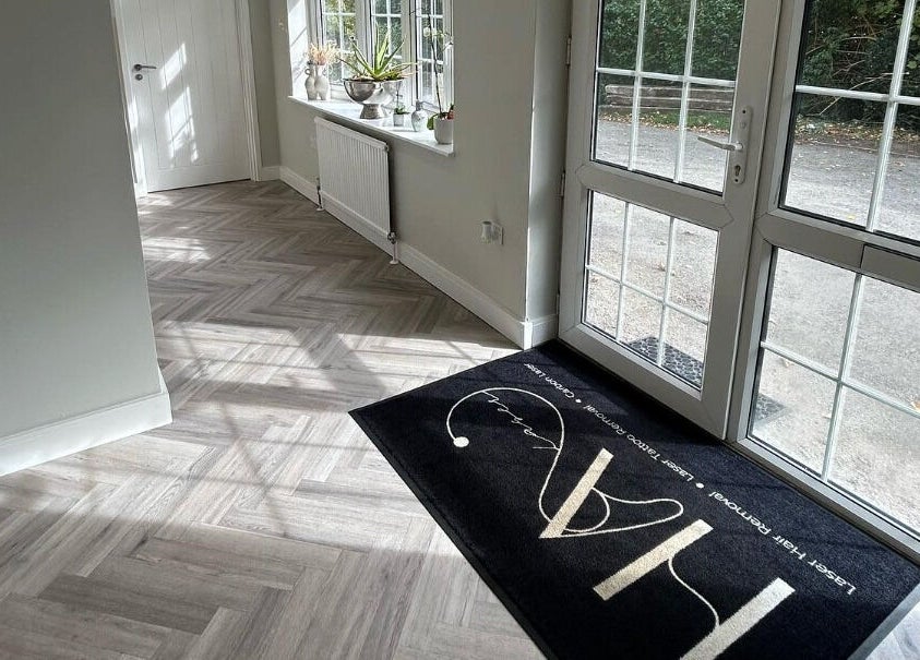 Bright entryway at HA Laser Studio, Basingstoke, England, GB, with modern flooring and a welcoming mat.
