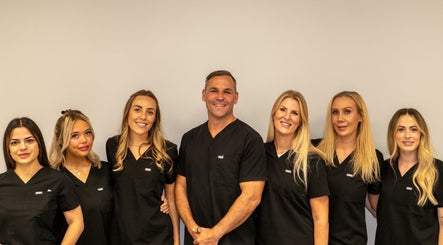 Team at HA Laser and Skin Studio Southampton in Hedge End, England, GB smiling in uniform.