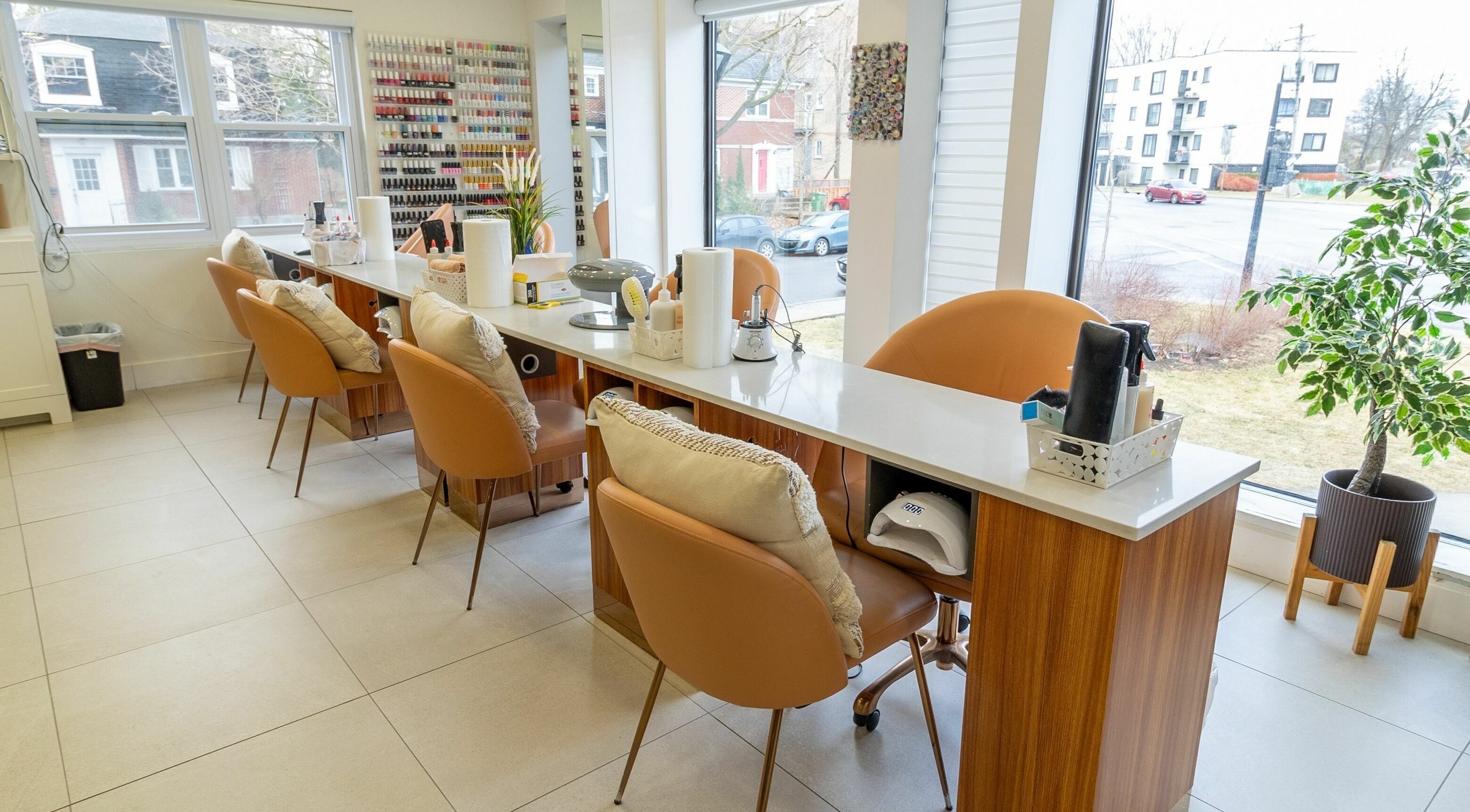 Modern nail station at Lolita Beaute, Montréal, Québec, CA with cozy chairs and a wide array of nail polishes.