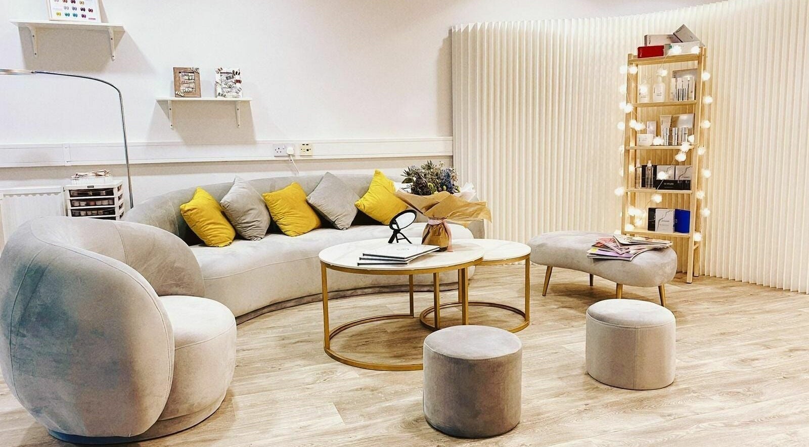Cozy seating area in Ka · O Beauty Salon, Sheffield, England, GB with plush sofas and decorative accents.
