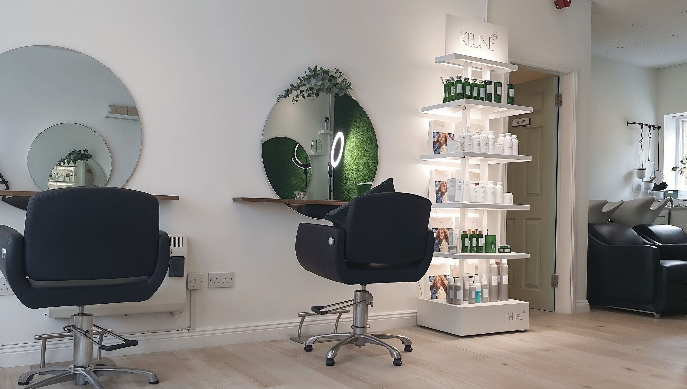 Modern salon interior at Martinas Hair Design, Clonakilty, County Cork, IE with styling chairs and product display.