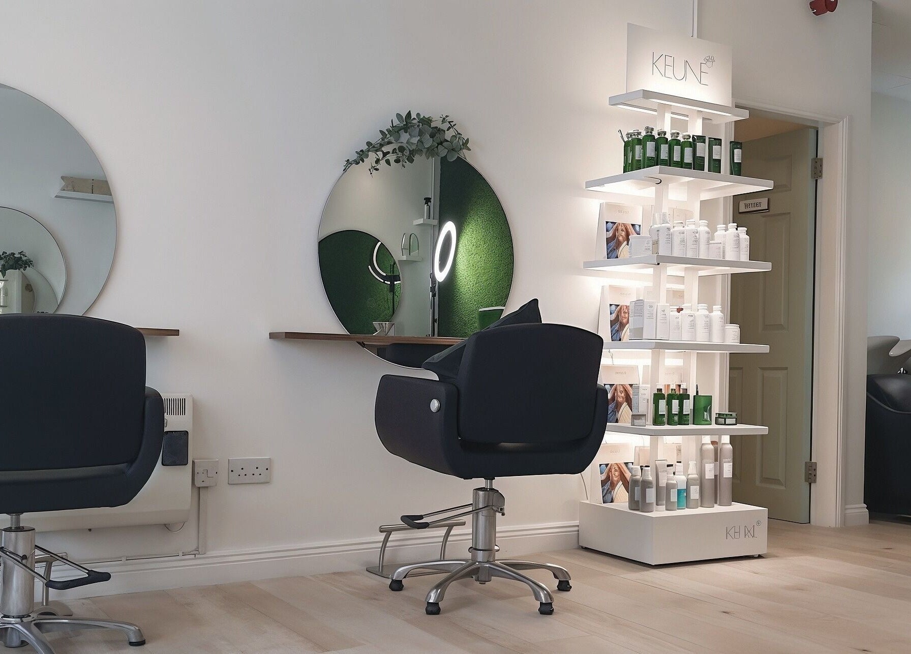 Modern salon interior at Martinas Hair Design, Clonakilty, County Cork, IE with styling chairs and product display.