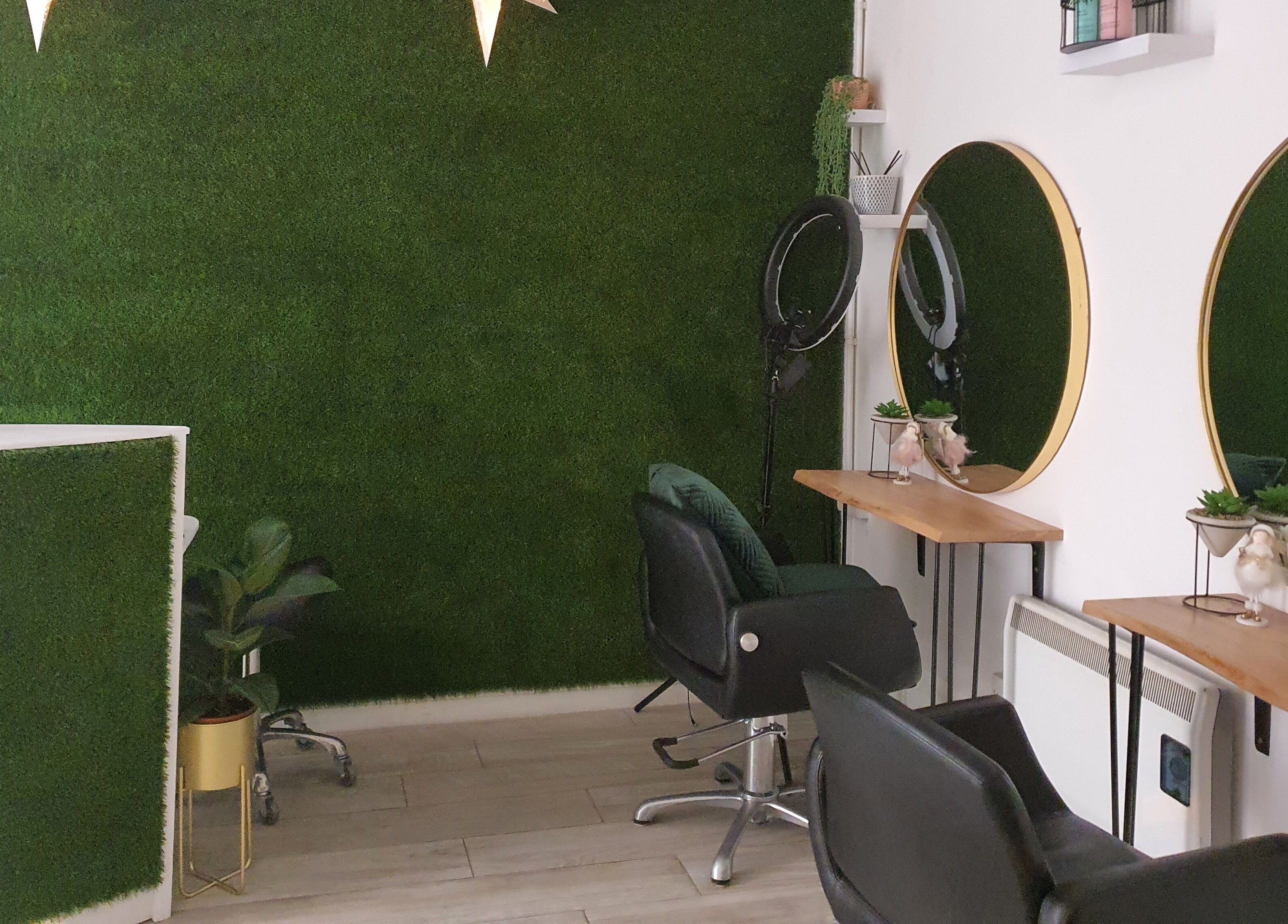 Elegant interior of Martinas Hair Design in Clonakilty, County Cork, IE with green walls and stylish mirrors.