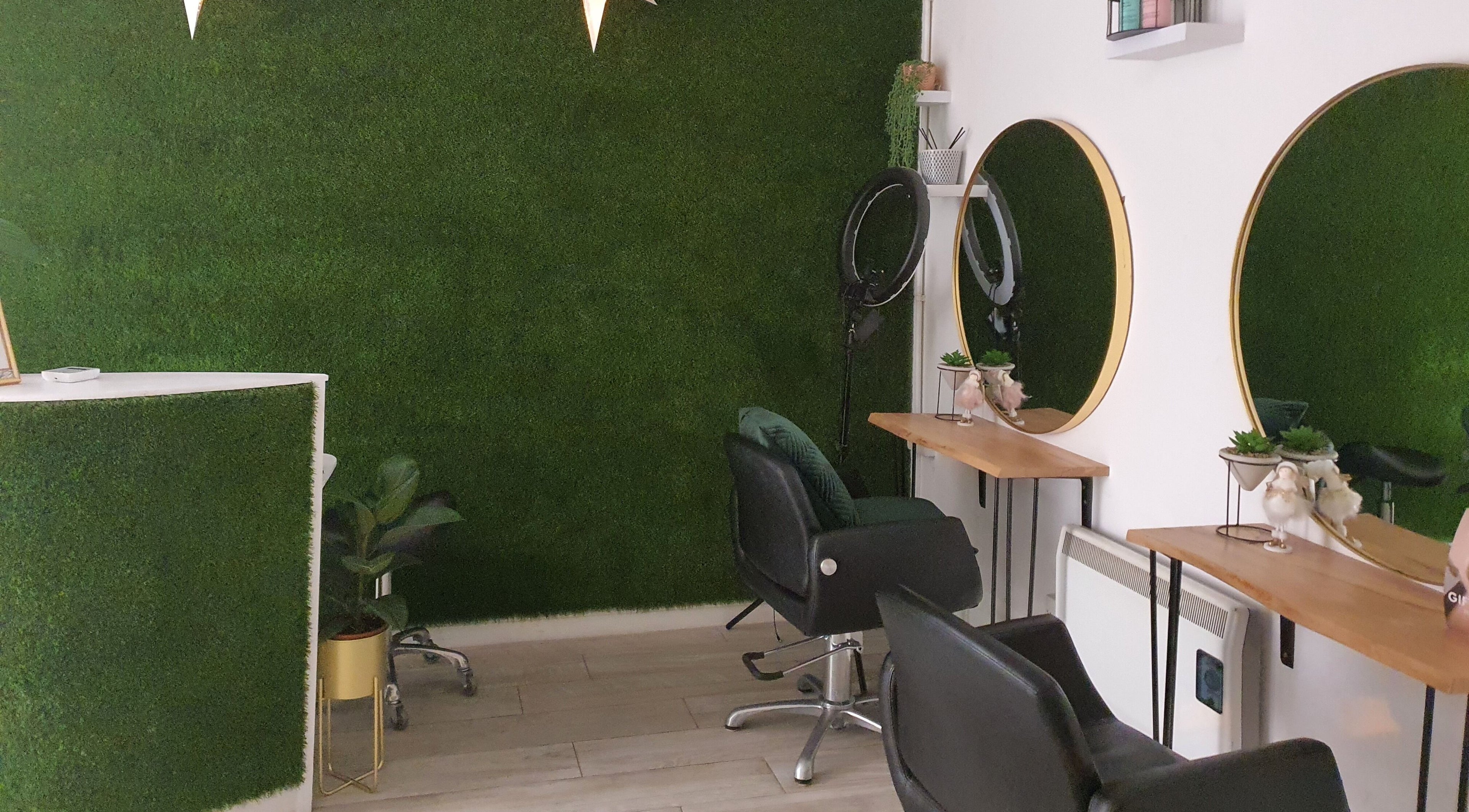 Elegant interior of Martinas Hair Design in Clonakilty, County Cork, IE with green walls and stylish mirrors.