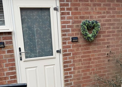Heart-shaped wreath on brick wall at Karen Brereton Aesthetics, Loughborough, England, GB.