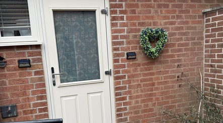 Heart-shaped wreath on brick wall at Karen Brereton Aesthetics, Loughborough, England, GB.