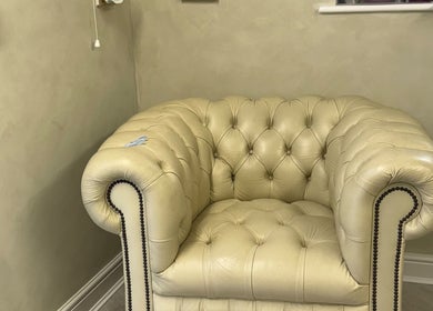 Elegant beige armchair at Karen Brereton Aesthetics, Loughborough, England, GB, offering comfort and style.