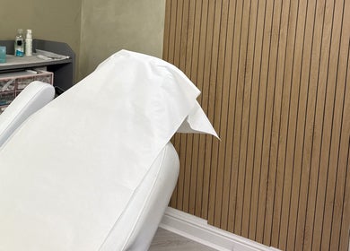 Relaxing treatment room at Karen Brereton Aesthetics, Loughborough, England, GB, featuring a comfortable white chair.