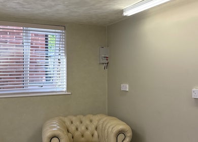 Cozy seating area at Karen Brereton Aesthetics, Loughborough, England, GB, featuring a plush armchair.