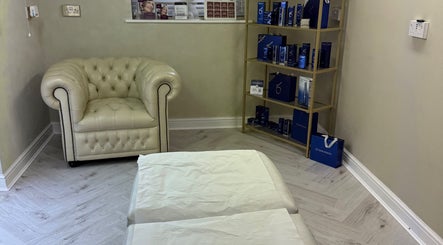 Cozy seating area at Karen Brereton Aesthetics in Loughborough, England, GB with products on display.