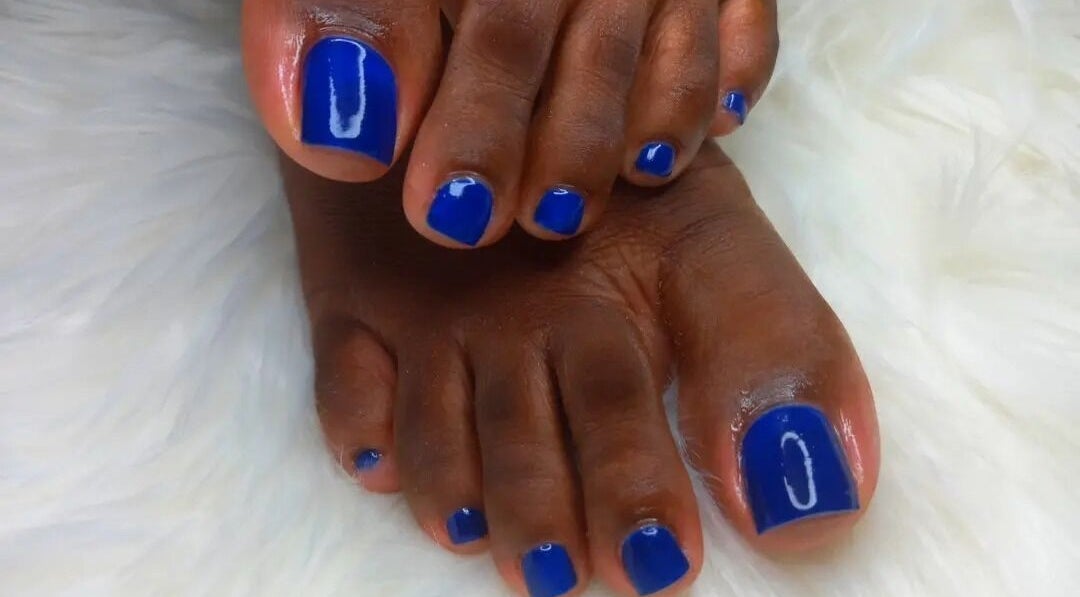 Bright blue pedicure at Clarkes Holistic Oasis, Bridgetown, Saint Michael, BB on a fluffy white surface.