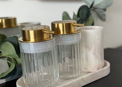 Elegant liquid dispensers with gold tops at AM Beauty Studios Kingsknowe, Edinburgh, Scotland, GB.