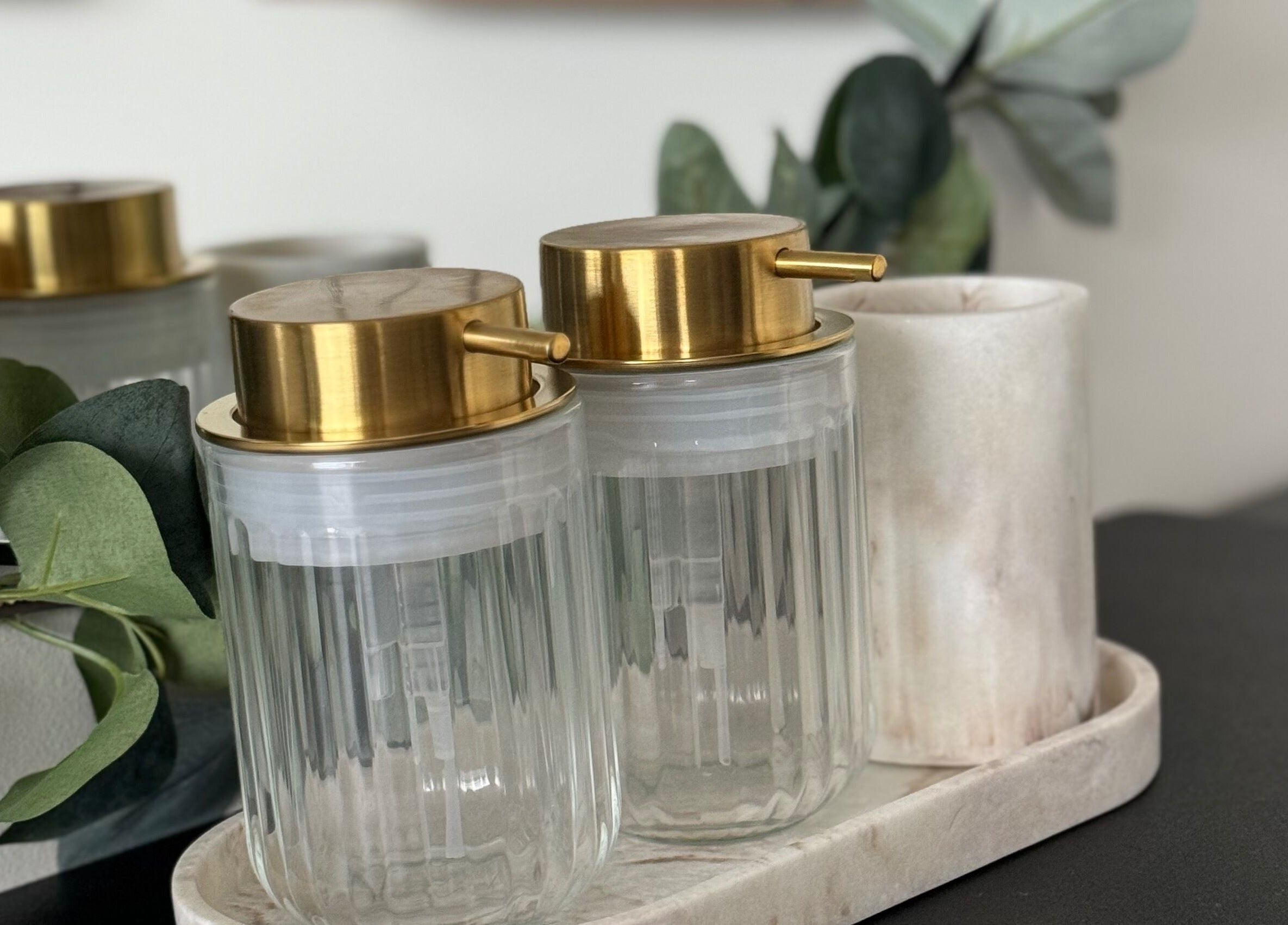 Elegant liquid dispensers with gold tops at AM Beauty Studios Kingsknowe, Edinburgh, Scotland, GB.