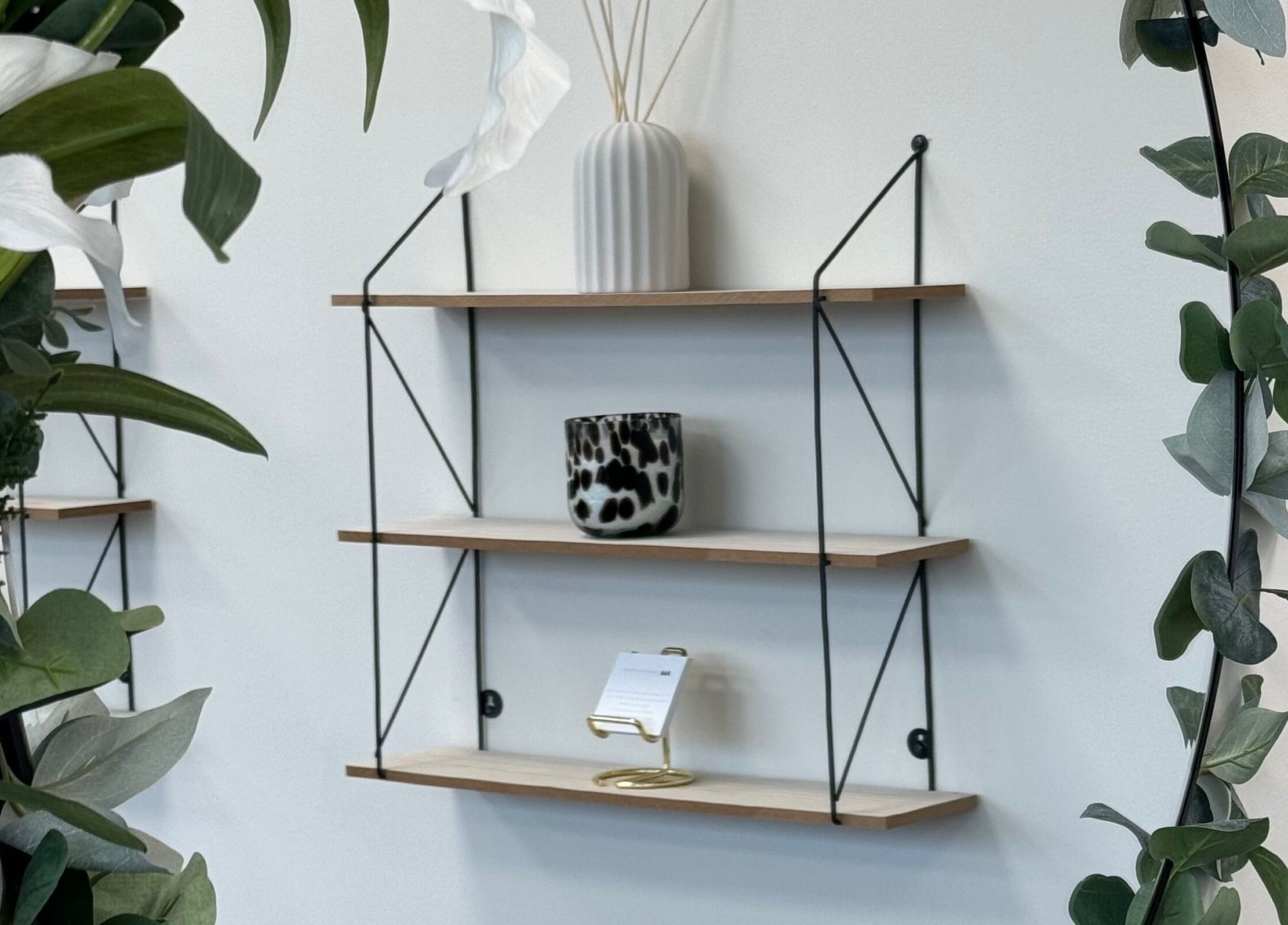Elegant shelves with decor at AM Beauty Studios Kingsknowe, Edinburgh, Scotland, GB, enhancing the serene ambiance.