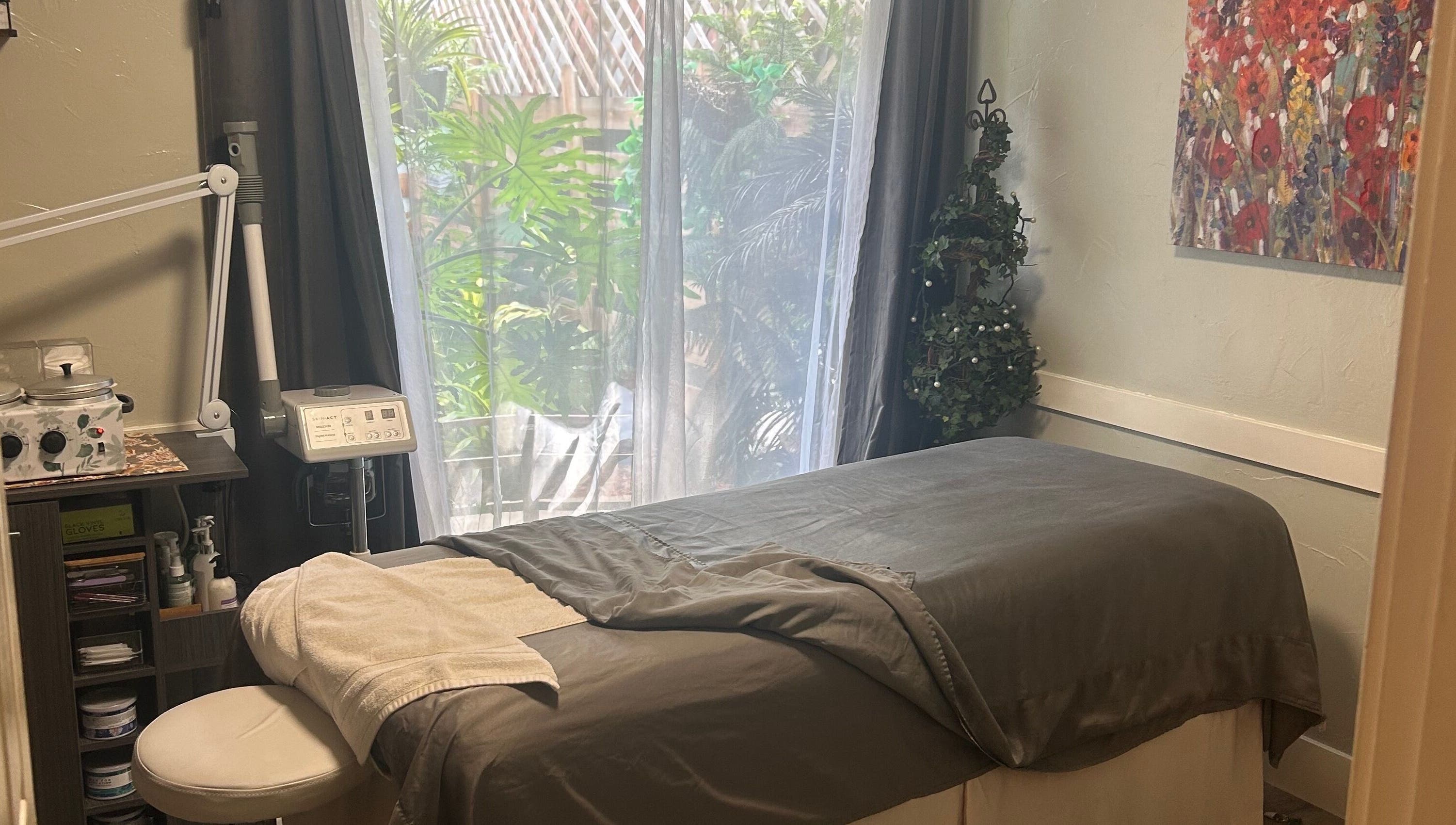 Tranquil spa room at 807 W Grand Blvd Ste C, Corona, Cal 92882, featuring a massage table and calming decor.