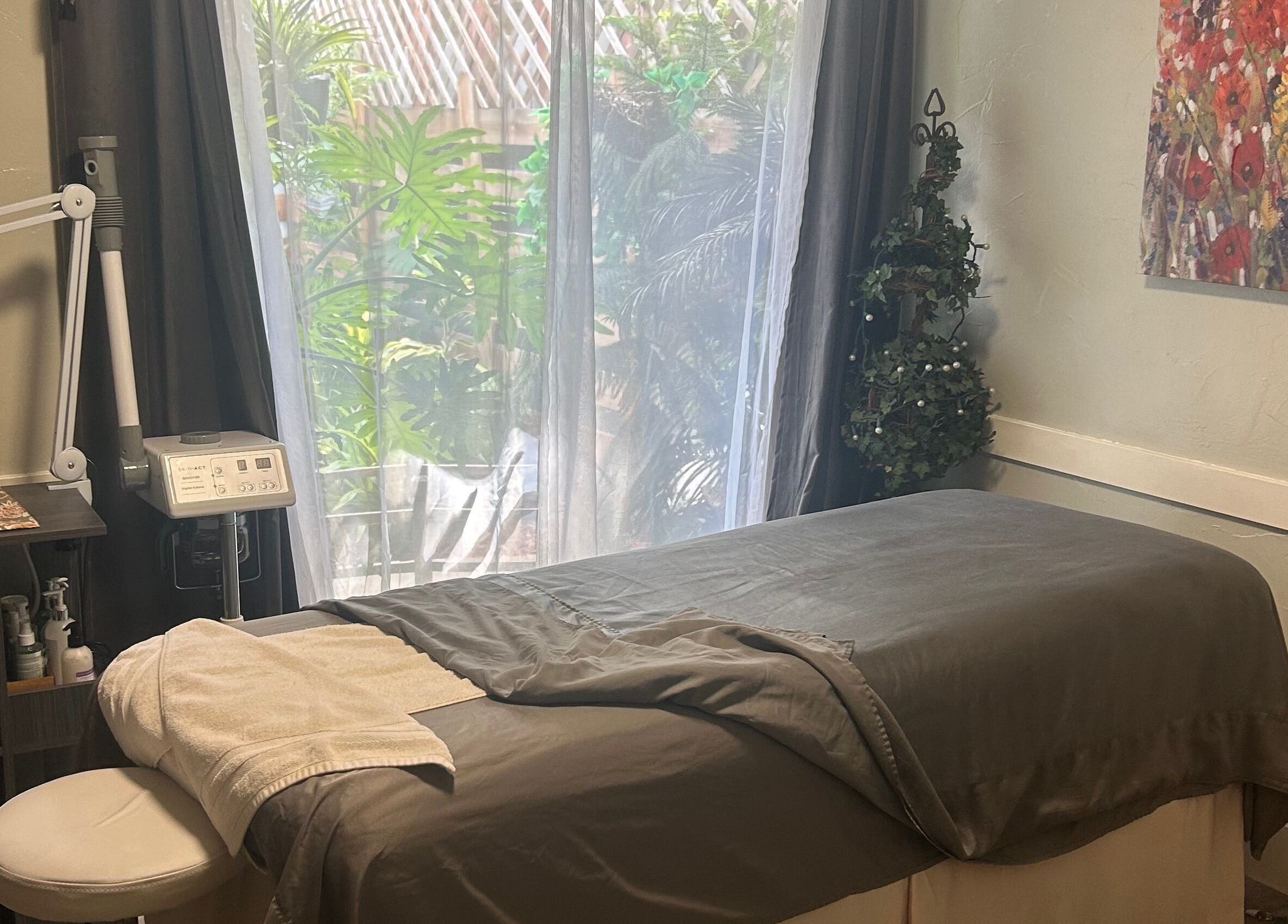 Tranquil spa room at 807 W Grand Blvd Ste C, Corona, Cal 92882, featuring a massage table and calming decor.