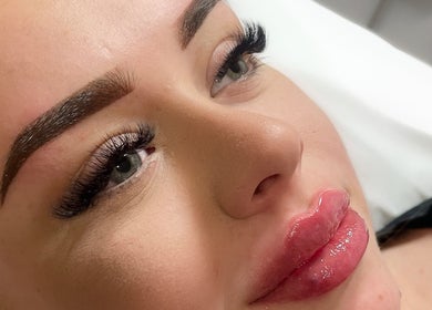 Woman with styled eyebrows and glossy lips at AE Clinics - Abigael Eva (Sudbury), Sudbury, England, GB.