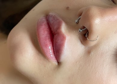 Close-up of stylish nose and lip piercings at AE Clinics - Abigael Eva, Colchester, England, GB.
