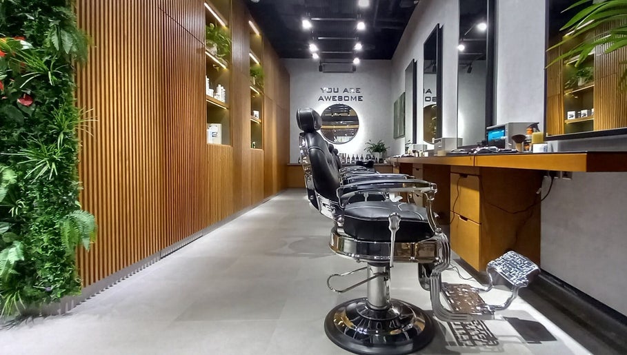 Elegant interior of Grow Organic Gents Salon in Dubai, AE, featuring sleek barber chairs and vertical garden.
