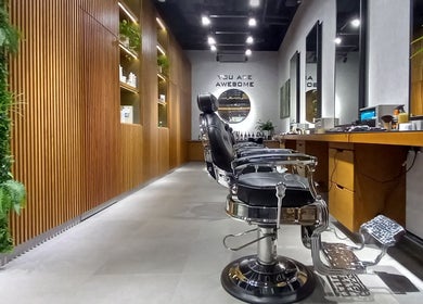 Elegant interior of Grow Organic Gents Salon in Dubai, AE, featuring sleek barber chairs and vertical garden.