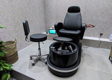 Luxurious pedicure chair at Grow Organic Gents Salon, Dubai, AE with modern interior details.