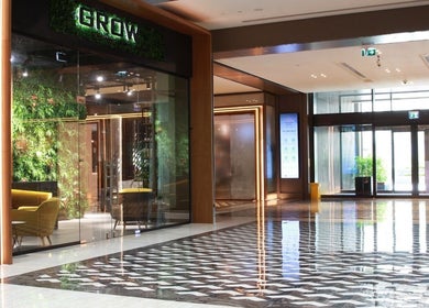 Luxurious entrance of Grow Organic Gents Salon in Dubai, AE with greenery and modern interior design.