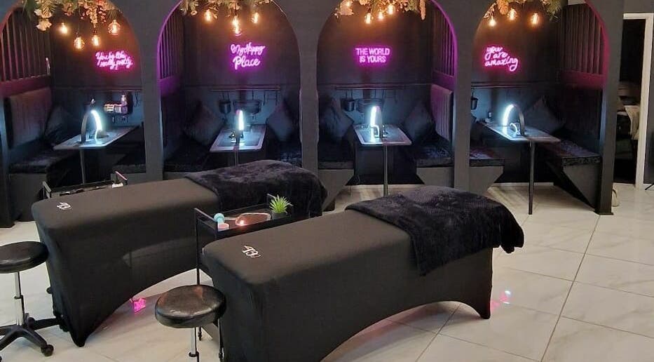 Elegant treatment room at Couture Lounge, Telford, England, GB with plush seating and ambient lighting.