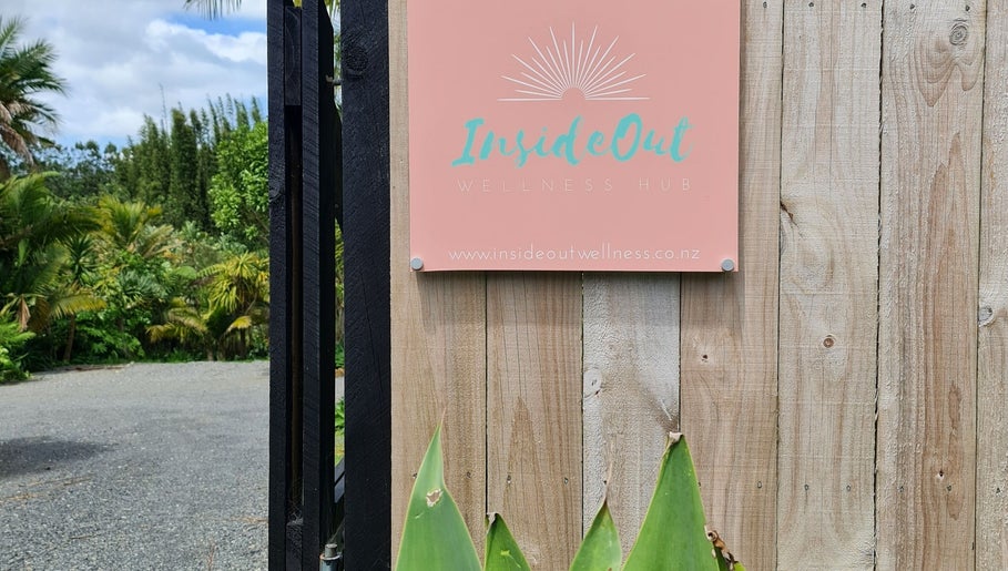 Entrance sign at Inside Out Beauty, Waipapa, Northland, NZ surrounded by lush greenery.