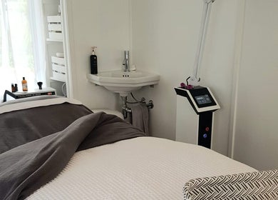 Relaxing treatment room at Inside Out Beauty, Waipapa, Northland, NZ, featuring spa bed and skincare products.