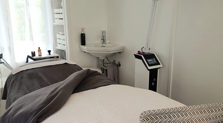 Relaxing treatment room at Inside Out Beauty, Waipapa, Northland, NZ, featuring spa bed and skincare products.