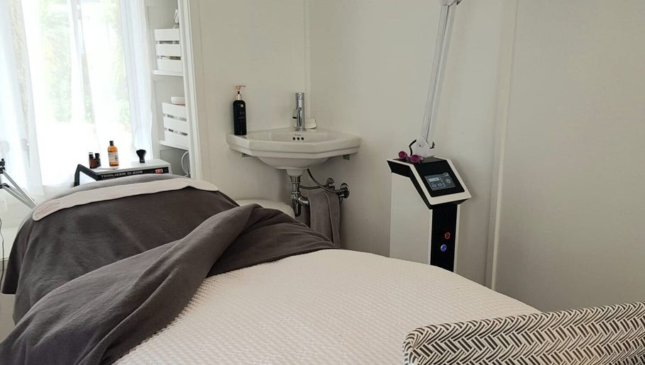Tranquil spa room at Inside Out Beauty, Waipapa, Northland, NZ, featuring a cozy treatment table and modern equipment.