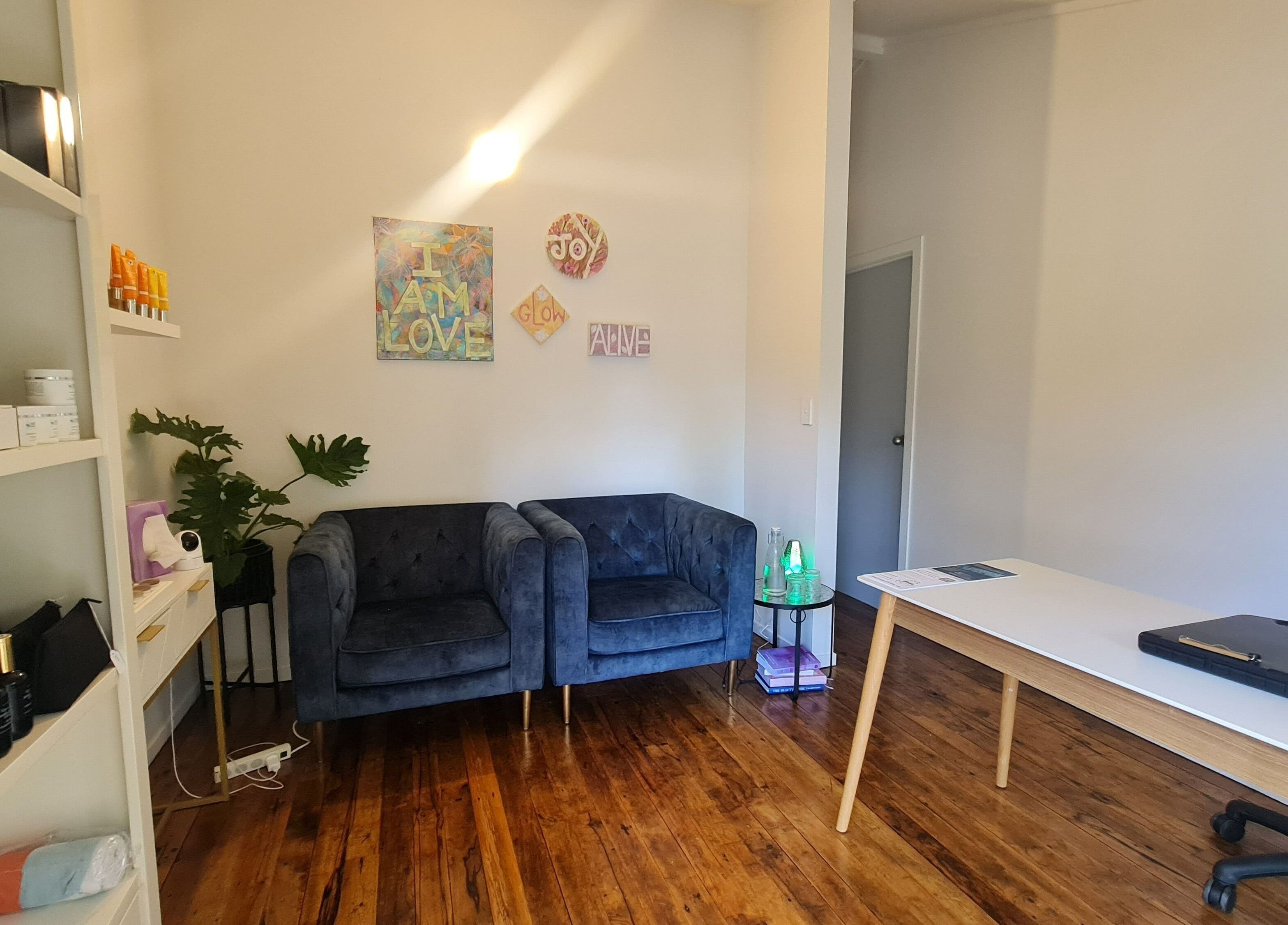 Elegant lounge at Inside Out Beauty, Waipapa, Northland, NZ with plush seating and wellness decor.