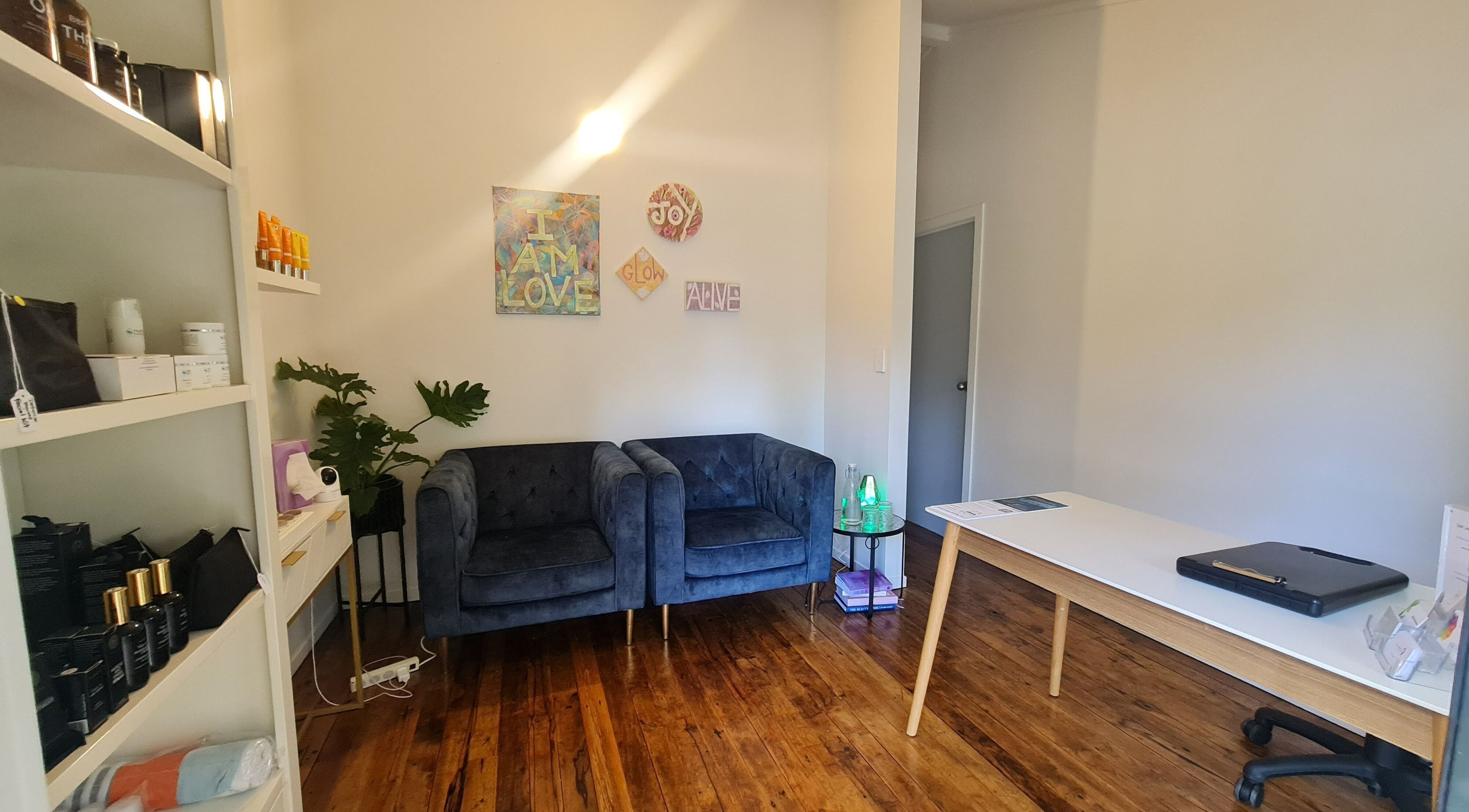 Elegant lounge at Inside Out Beauty, Waipapa, Northland, NZ with plush seating and wellness decor.